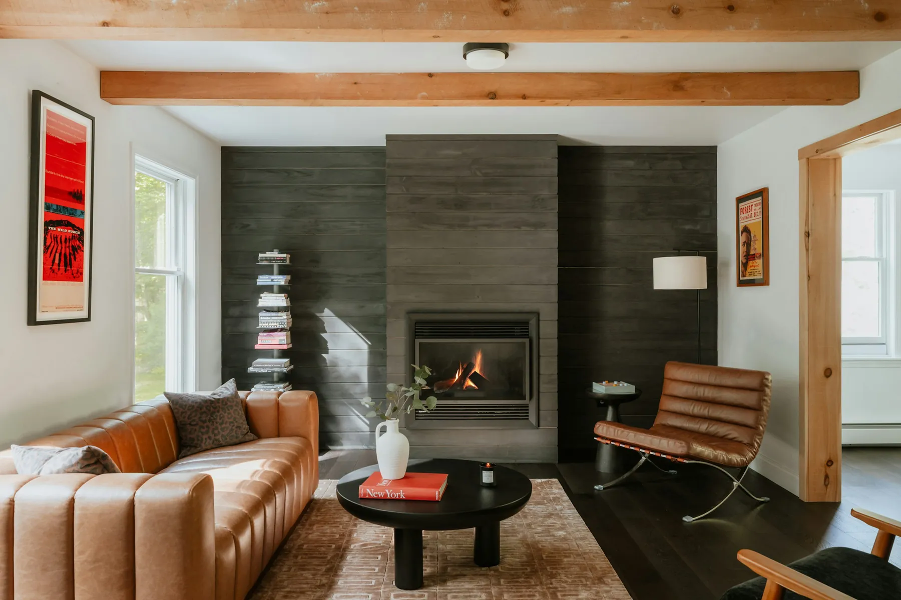 After: living room with a dark tiled fireplace feature wall
