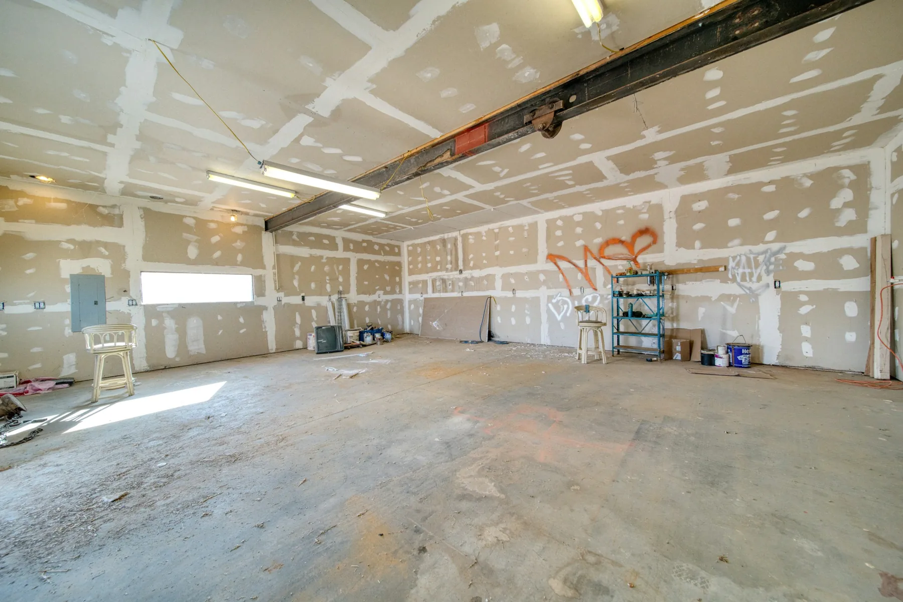 Before: open commercial space with unfinished drywall